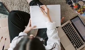 Woman writing in planner