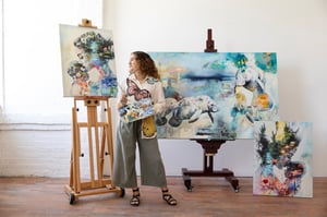 Women in studio with art and easel 