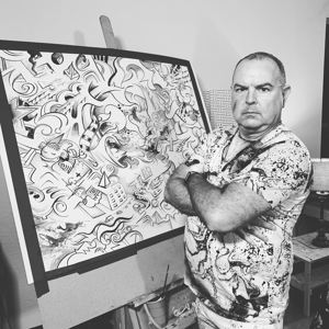 man standing in front of black and white art paper drawing