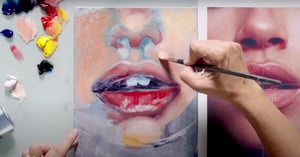 Hand painting portrait with paintbrush 