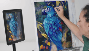 woman painting blue parrot 