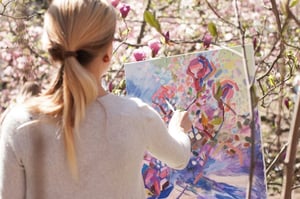 Artist painting at an easel