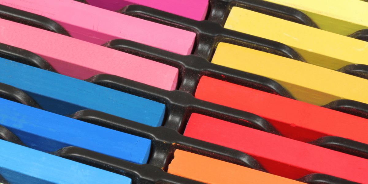 Colorful chalk pastels stored upright in a container