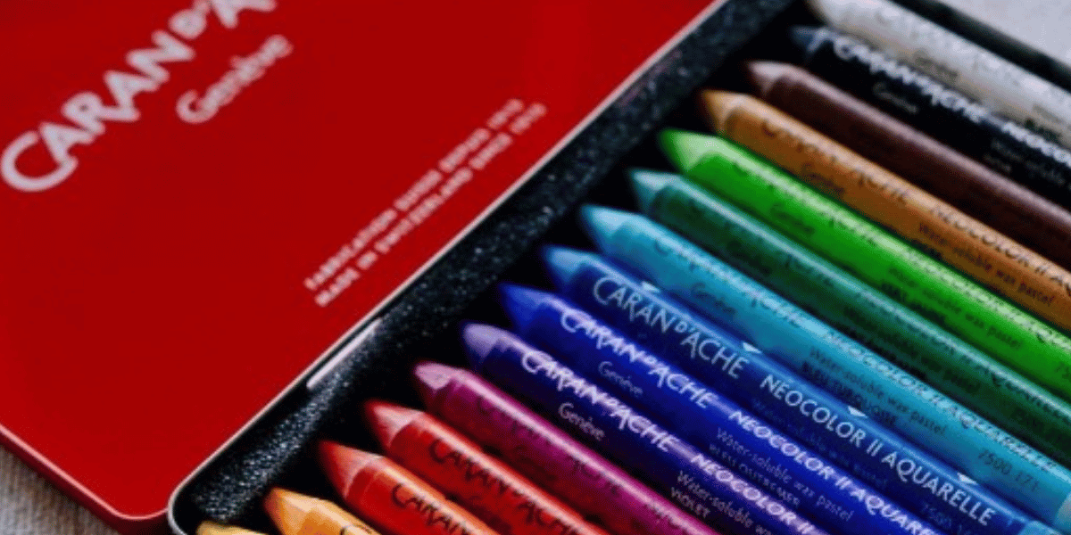 Set of colorful soft pastels in a red metal tin